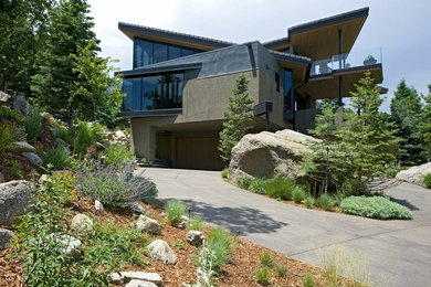 Inspiration for a large modern full sun front yard mulch driveway in Denver.
