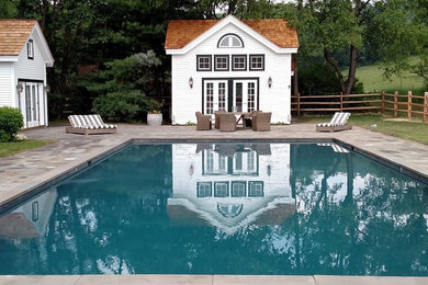 Pool - traditional backyard stone and rectangular pool idea in New York