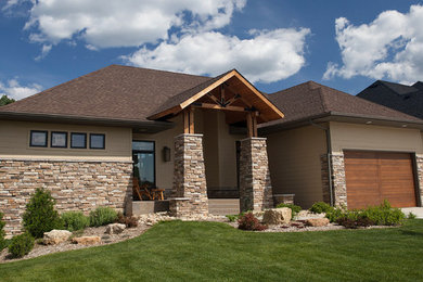 Large elegant beige one-story mixed siding exterior home photo in Minneapolis with a hip roof