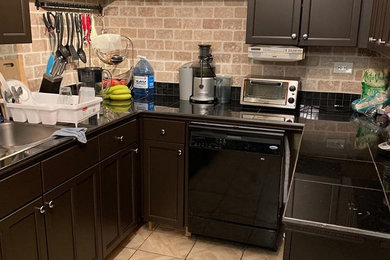 Example of a minimalist kitchen design in Toronto with brown cabinets