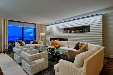 Living room - large contemporary enclosed dark wood floor and brown floor living room idea in Chicago with orange walls, a media wall and no fireplace