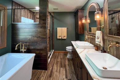 Bathroom - mid-sized rustic master brown tile medium tone wood floor, brown floor and double-sink bathroom idea in Cleveland with raised-panel cabinets, dark wood cabinets, a two-piece toilet, green walls, a vessel sink, quartz countertops, white countertops, a niche and a built-in vanity