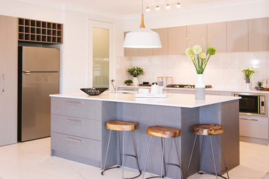 Design ideas for a mid-sized contemporary l-shaped eat-in kitchen in Sydney with an undermount sink, flat-panel cabinets, grey cabinets, laminate benchtops, white splashback, porcelain splashback, stainless steel appliances, marble floors and with island.