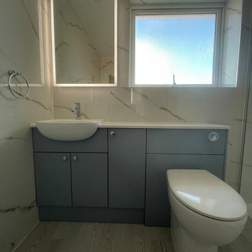 Simple and efficient bathroom with built-in storage and walk-in shower