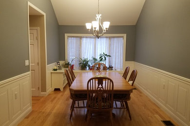 Example of a mid-sized trendy light wood floor kitchen/dining room combo design in New York with gray walls