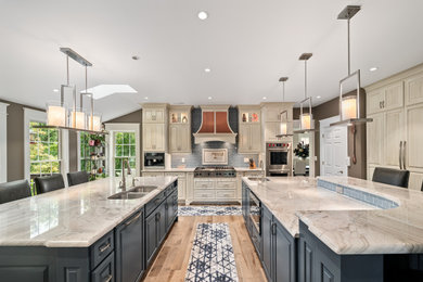 Example of a trendy eat-in kitchen design in Other with quartzite countertops, two islands and beige countertops
