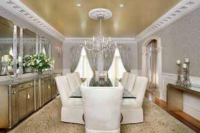 Example of a huge transitional medium tone wood floor enclosed dining room design in DC Metro