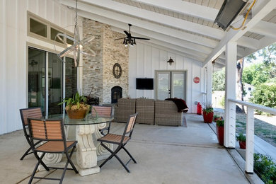 Inspiration for a large farmhouse concrete back porch remodel in Sacramento with a fire pit and a roof extension