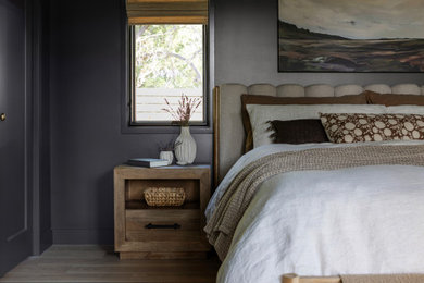 Example of a transitional light wood floor and beige floor bedroom design in San Francisco with gray walls