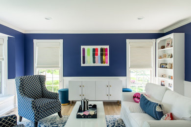 Inspiration for a mid-sized transitional enclosed light wood floor living room remodel in Chicago with blue walls