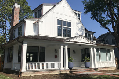 Inspiration for a large farmhouse white three-story wood house exterior remodel in Chicago with a mixed material roof
