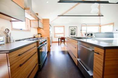 Small minimalist light wood floor eat-in kitchen photo in Seattle with an undermount sink, medium tone wood cabinets, white backsplash, stainless steel appliances and an island