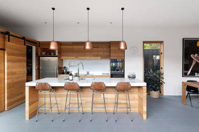 Inspiration for a bohemian kitchen in Melbourne with a double-bowl sink, black appliances, ceramic flooring and grey floors.