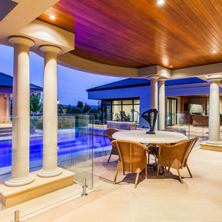 Photo of a transitional backyard patio in Perth with natural stone pavers and a roof extension.