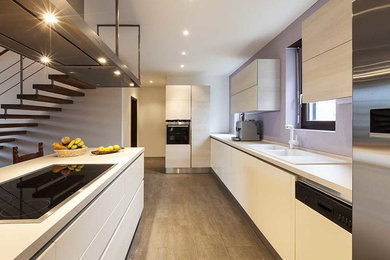 Inspiration for a mid-sized contemporary u-shaped porcelain tile and brown floor kitchen remodel in Miami with an undermount sink, flat-panel cabinets, white cabinets, white appliances and a peninsula