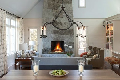 Large formal and open concept dark wood floor living room photo in Portland Maine with blue walls, a standard fireplace, a stone fireplace and no tv