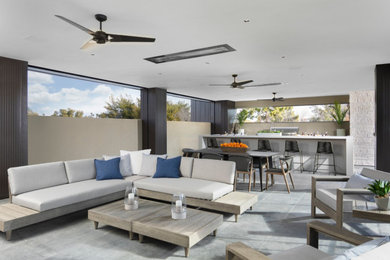 Patio kitchen - large contemporary backyard patio kitchen idea in Las Vegas