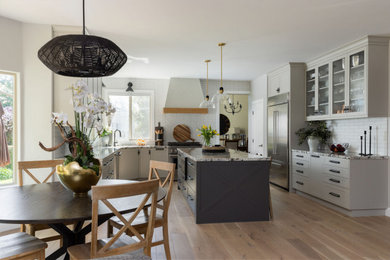 Inspiration for a transitional u-shaped open concept kitchen remodel in Sacramento with an island