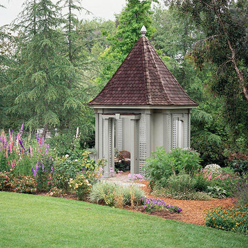 Custom gazebo with wood shingles, lattice for privacy screening and seating in