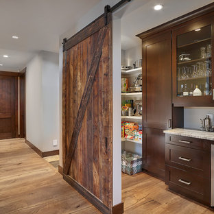 Mid-sized craftsman kitchen pantry designs - Example of a mid-sized arts and crafts l-shaped medium tone wood floor kitchen pantry design in Edmonton with shaker cabinets, dark wood cabinets, granite countertops and stainless steel appliances