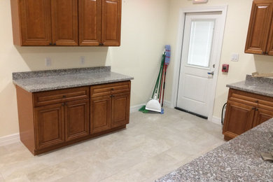 Inspiration for a timeless kitchen remodel in Houston with raised-panel cabinets, medium tone wood cabinets and granite countertops