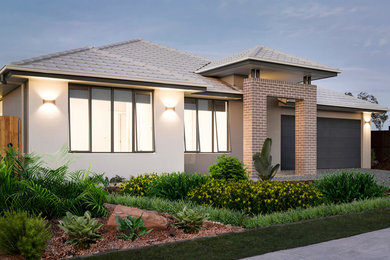 Design ideas for a large modern one-storey concrete house exterior in Brisbane with a hip roof.