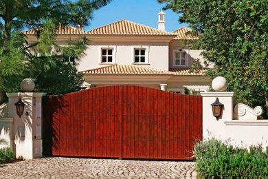 Large traditional beige two-story stucco house exterior idea in Salt Lake City with a hip roof and a tile roof