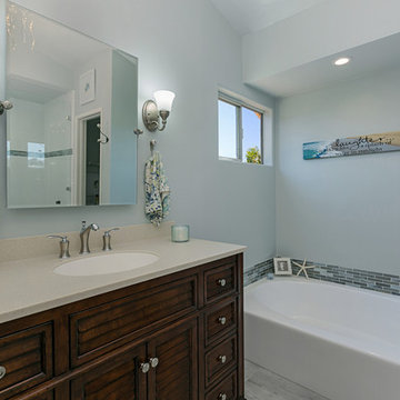 Oceanside Master Bathroom with Dark Vanity and Built In Tub