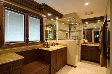Example of a mid-sized minimalist master beige tile and ceramic tile ceramic tile bathroom design in Atlanta with an undermount sink, raised-panel cabinets, medium tone wood cabinets, granite countertops, a one-piece toilet and beige walls