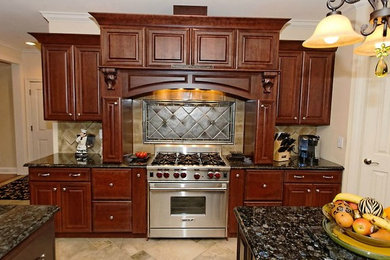 Inspiration for a timeless kitchen remodel in Boston with raised-panel cabinets, dark wood cabinets and stainless steel appliances