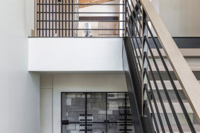 Inspiration for a mid-sized contemporary light wood floor and brown floor wine cellar remodel in Denver with storage racks