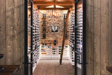 Large urban brick floor and gray floor wine cellar photo in San Francisco with storage racks