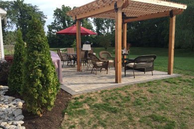 Inspiration for a mid-sized arts and crafts backyard patio in Cincinnati with a fire feature, brick pavers and a pergola.