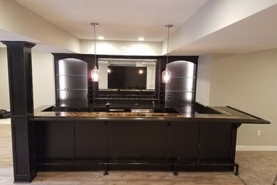 Example of a large classic underground laminate floor and brown floor basement design in Other with gray walls