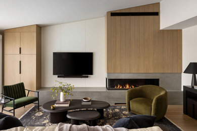 Living room - mid-sized contemporary open concept light wood floor living room idea in Calgary with white walls, a two-sided fireplace, a tile fireplace and a wall-mounted tv