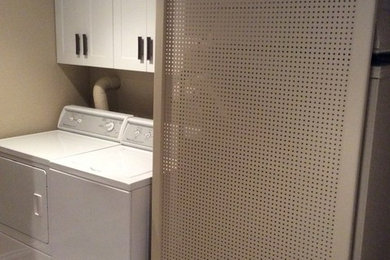 Mid-sized elegant galley dedicated laundry room photo in Chicago with shaker cabinets, white cabinets, beige walls and a side-by-side washer/dryer