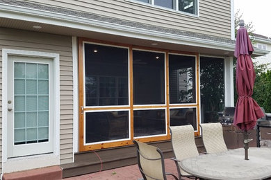 Example of a mid-sized trendy gray two-story wood exterior home design in Other with a shed roof