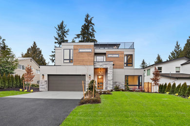 Large modern gray three-story mixed siding and board and batten exterior home idea in Seattle