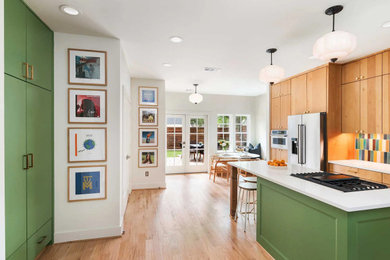 Inspiration for a mid-sized transitional l-shaped light wood floor and beige floor eat-in kitchen remodel in Dallas with flat-panel cabinets, medium tone wood cabinets, quartz countertops, multicolored backsplash, ceramic backsplash, stainless steel appliances, an island and white countertops