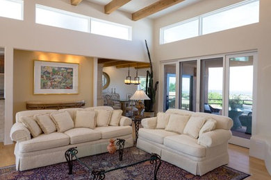 Inspiration for a large timeless formal and open concept light wood floor living room remodel in Orange County with white walls, a corner fireplace and no tv