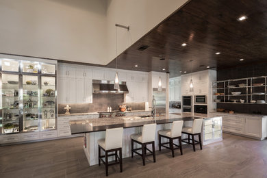 Inspiration for a huge contemporary porcelain tile kitchen remodel in Houston with an undermount sink, recessed-panel cabinets, white cabinets, granite countertops, gray backsplash, stainless steel appliances and an island