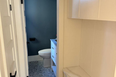 Inspiration for a contemporary powder room remodel in Toronto with white cabinets, blue walls and white countertops
