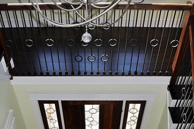 Inspiration for a large transitional porcelain tile entryway remodel in Boston with green walls and a dark wood front door
