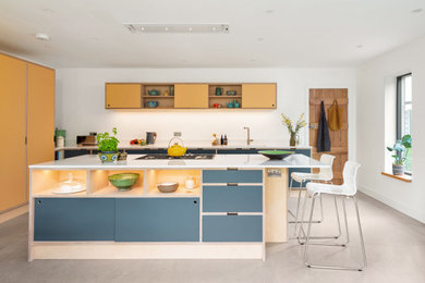 Inspiration for a medium sized contemporary kitchen in Oxfordshire with a submerged sink, flat-panel cabinets, yellow cabinets, concrete flooring, an island, grey floors and white worktops.