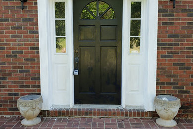Example of a mid-sized classic entryway design in Charleston with a black front door