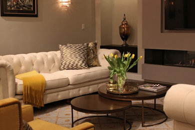 Living room - mid-sized transitional formal and open concept medium tone wood floor living room idea in Boston with gray walls, a hanging fireplace and a wall-mounted tv