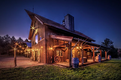Mid-sized mountain style brown two-story wood exterior home photo in Other with a metal roof