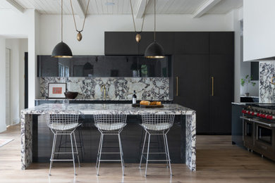 Example of a large trendy l-shaped medium tone wood floor, brown floor and shiplap ceiling kitchen design in Orange County with marble countertops, multicolored backsplash, stainless steel appliances, an island, multicolored countertops, flat-panel cabinets and marble backsplash