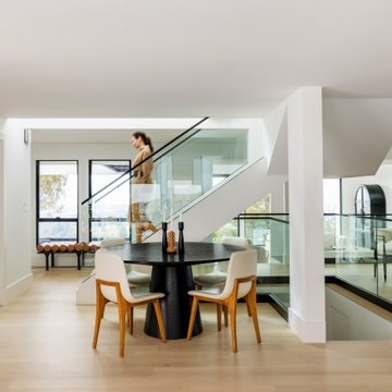A Glass-Railed Staircase Bridging Three Levels