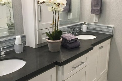 Mid-sized transitional multicolored tile and glass tile porcelain tile and multicolored floor bathroom photo in Portland with shaker cabinets, white cabinets, a two-piece toilet, gray walls, an undermount sink and quartz countertops